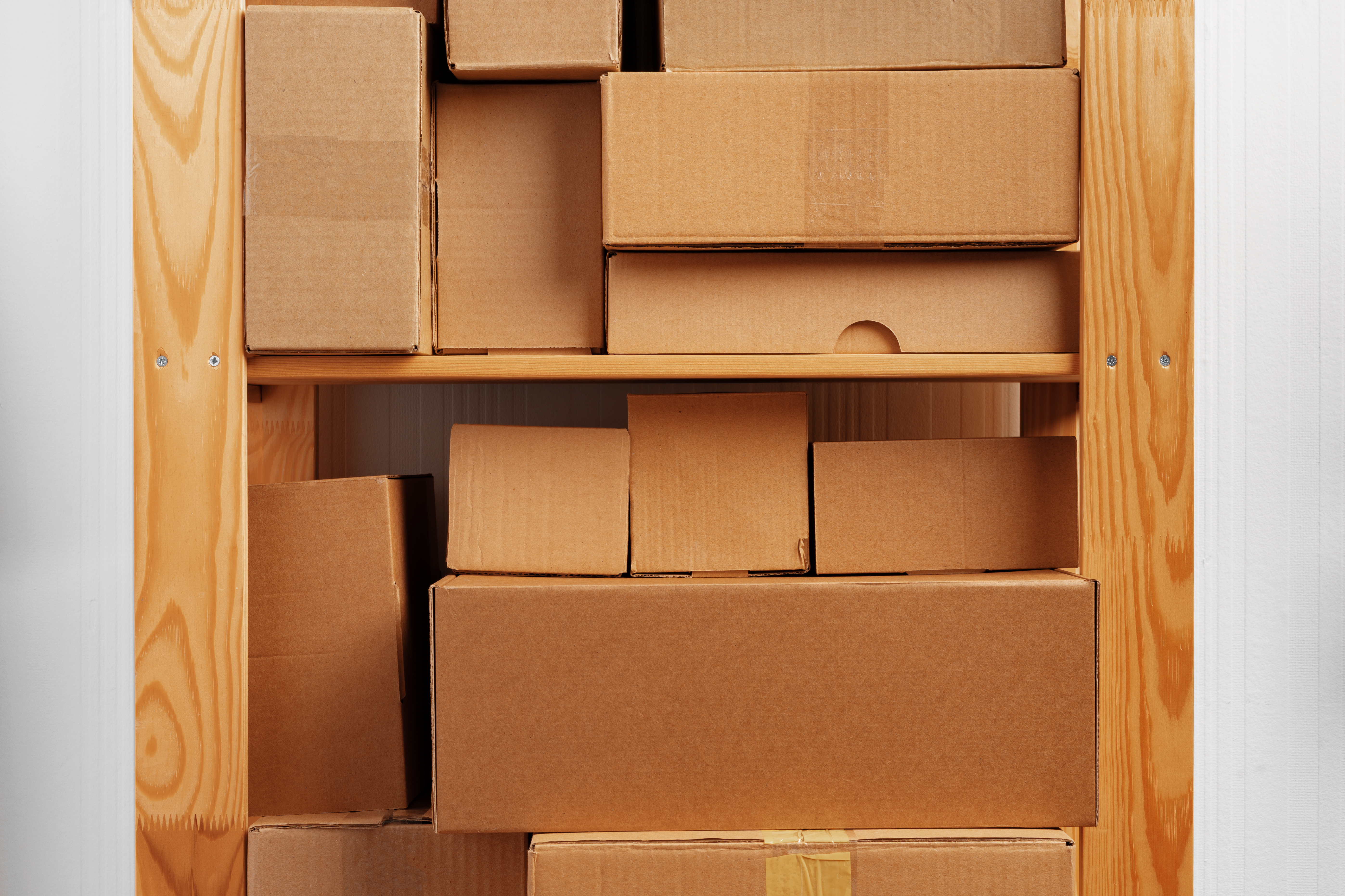 Stack of cardboard package boxes on wooden rack