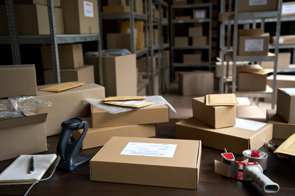 Warehouse background shipping orders package boxes on table.